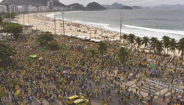 People take part in a pro-government demonstration at Copacabana beach in Rio de Janeiro, Brazil, yesterday.