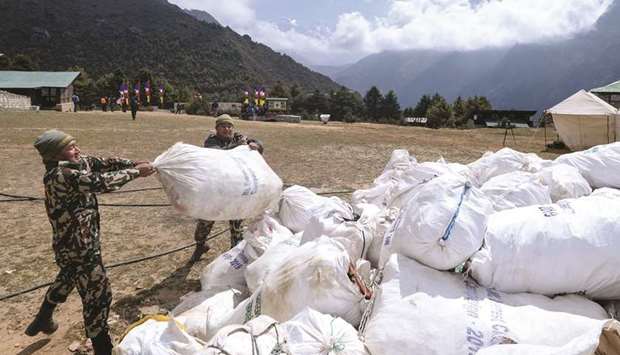 Nepali Army personnel carry bags of waste collected from the Mt Everest at Namche Bazar, yesterday, before it is transported to Kathmandu to be recycled.