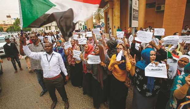Employees demonstrate outside Bank of Khartoum yesterday, as they participate in a two-day national strike to step up pressure on the ruling military council.