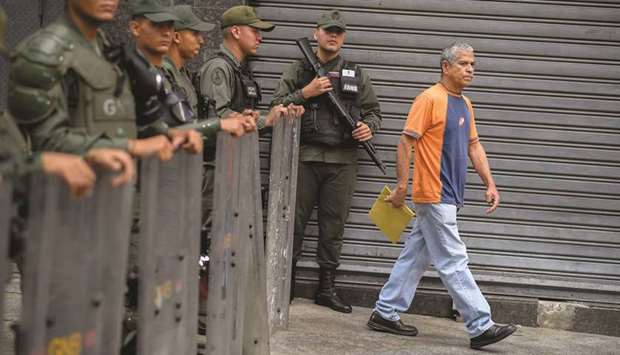 Members of Venezuelau2019s Bolivarian National Guard block the pressu2019 access to the Federal Legislative Palace, which houses both the opposition-led National Assembly and the pro-government National Constituent Assembly, in Caracas yesterday.