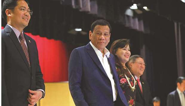 President Rodrigo Duterte is seen on his arrival at the Imperial Hotel where he attended a business forum yesterday. With him is his partner Cielito Avancena and Trade Secretary Ramon Lopez.