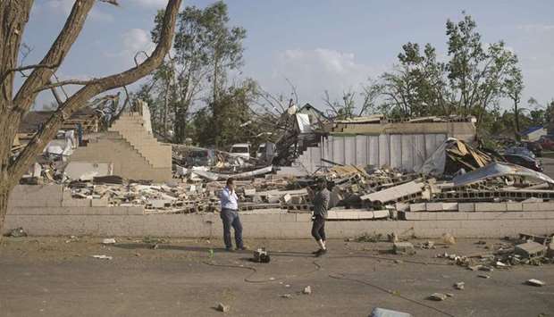 A TV news crew broadcasts from a destroyed neighbourhood in north Dayton where a powerful tornado touched down on Tuesday morning in Dayton, Ohio.