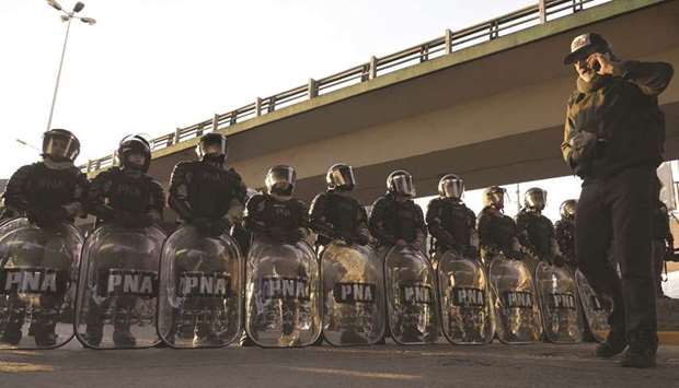 Members of the Argentine Naval Prefecture stand guard as activists of leftist parties and social organisations block the Pueyrredon bridge in Buenos Aires yesterday during a 24-hour general strike called by workersu2019 unions to demand the government of Argentine President Mauricio Macri to take measures against inflation and keep the campaign promises.