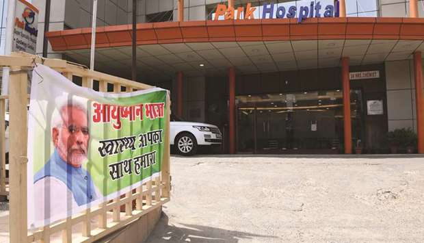 A banner for Ayushman Bharat, commonly known as the u201cModicareu201d healthcare scheme, is pictured at a gate at a hospital in Gurgaon in Haryana.