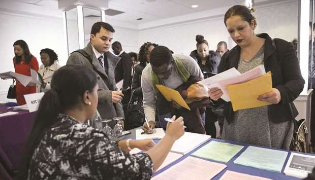 A New York Department of City Administrative Services representative, left, speaks with job seekers during a Catalyst Career Group job fair in New York.