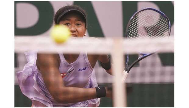Japanu2019s Naomi Osaka eyes the ball as she plays against Belarusu2019 Victoria Azarenka (not pictured) during their womenu2019s singles second round match on day five of the French Open at Roland Garros in Paris yesterday. (AFP)
