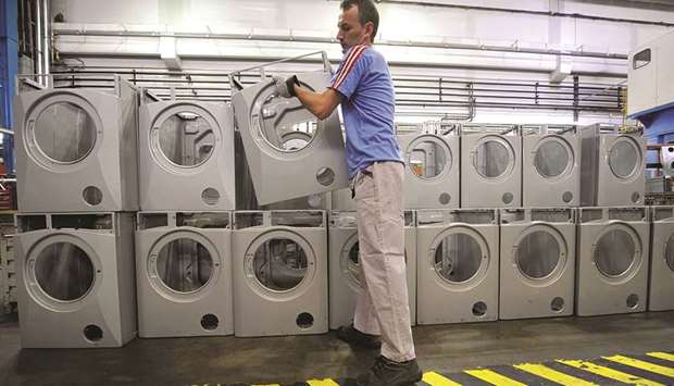 A worker arranges washing machines at a factory of Sloveniau2019s largest household appliances maker Gorenje in Velenje. Global factory activity recovered a little last month but still appeared to be in the doldrums as demand remained weak and trade protectionism concerns prominent, while stimulus measures had yet to fully kick in.