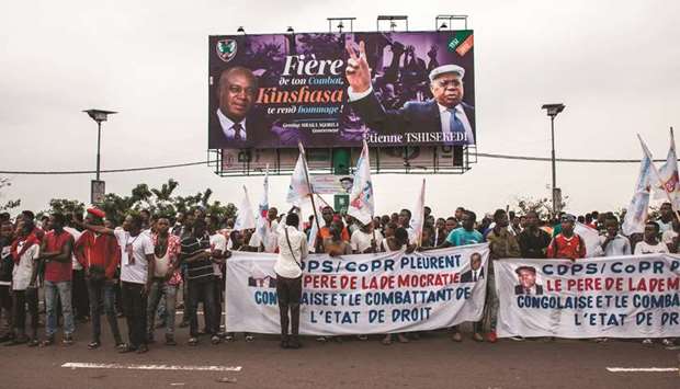 Supporters of late Congolese opposition leader Etienne Tshisekedi wait outside the airport in Kinshasa yesterday.