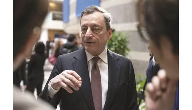 ECB president Mario Draghi speaks with delegates after the Group of 20 (G-20) finance ministers and central bank governors group photo on the sidelines of the spring meetings of the International Monetary Fund (IMF) and World Bank in Washington, D.C. on April 12. Draghi is likely to be reluctant to pull out bigger policy guns for now after first-quarter growth came in well above expectations and bank lending continued to move higher.
