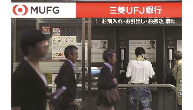 Customers use automated teller machines at a MUFG Bank branch in Tokyo. The Japanese lender is offering voluntary redundancy packages to about 500 directors and managing directors in London, according to an e-mailed statement. Thatu2019s roughly a quarter of its workforce in the city.