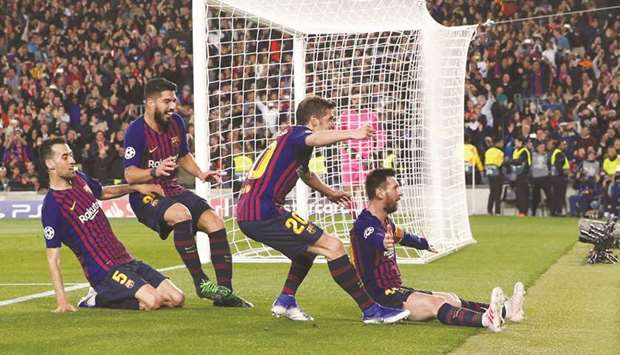 Barcelonau2019s Lionel Messi (right) celebrates after scoring against Liverpool in the Champions League semi-final first leg in Barcelona on Wednesday night. (Reuters)