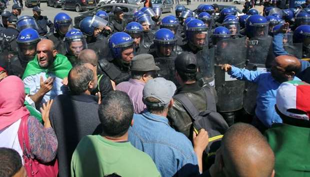 Police officers prevent demonstrators from marching during a May Day protest on Labour Day in Algiers, Algeria