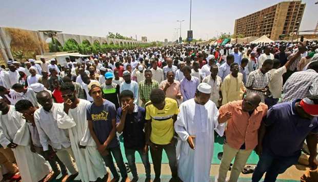 Sudanese protesters gather during Friday noon prayers outside the army headquarters in Khartoum.