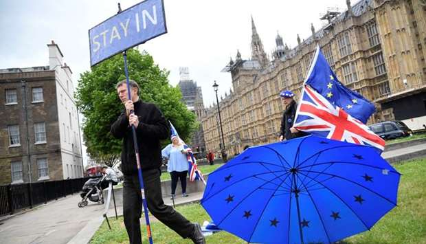 Anti-Brexit protesters are seen near the Houses of Parliament in London. 