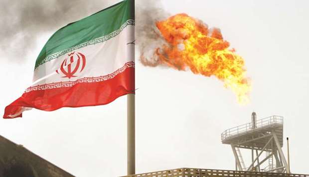 A gas flare on an oil production platform in the Soroush oil fields is seen alongside an Iranian flag in Gulf (file). More than 130mn barrels of oil were exported from Iranu2019s offshore fields in the fiscal year that ended March 20, said Hamid Bovard, head of the Iranian Offshore Oil Co.