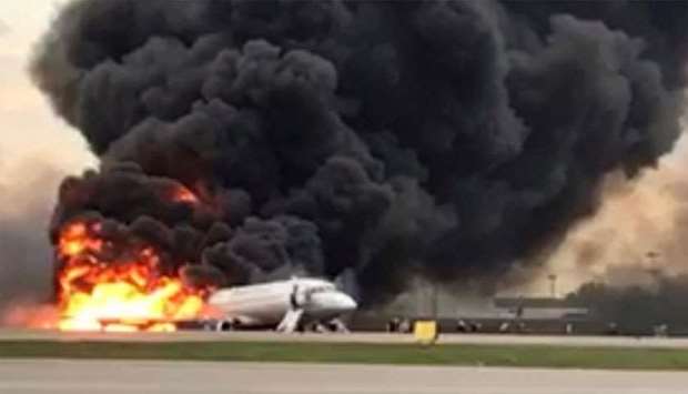 A passenger plane is seen on fire after an emergency landing at the Sheremetyevo Airport outside Mos