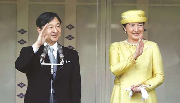Japanu2019s Emperor Naruhito and Empress Masako greet well-wishers during their first public appearance at the Imperial Palace in Tokyo yesterday.