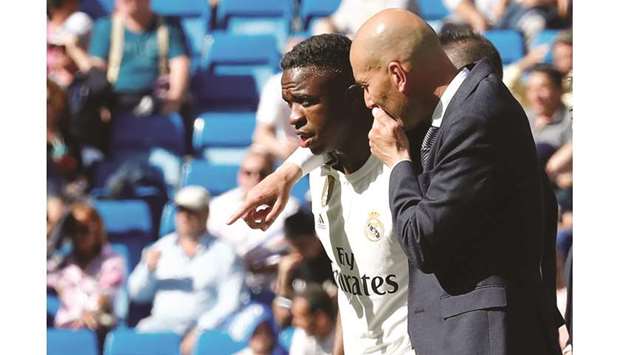 Real Madridu2019s Vinicius Junior receives instructions from coach Zinedine Zidane before being substituted yesterday.