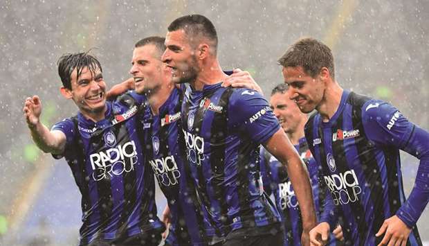 Atalantau2019s defender from Albania Berat Djimsiti (C) celebrates with his teammates after scoring against Lazio during their Italian Serie A football match at the Olympic stadium in Rome.