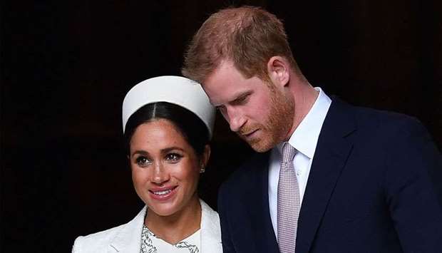 Britain's Prince Harry, Duke of Sussex (R) and Meghan, Duchess of Sussex