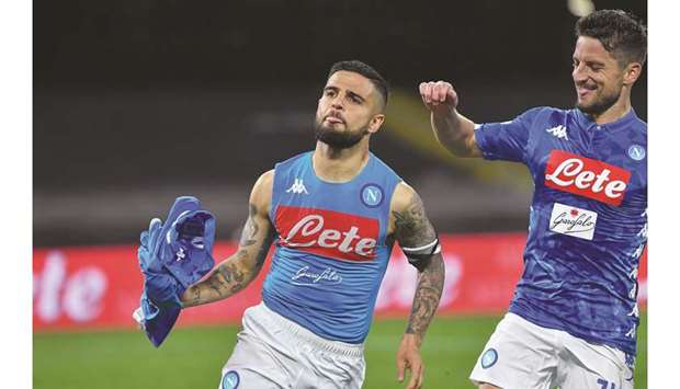 Napoliu2019s Lorenzo Insigne (left) celebrates after scoring a 98th-minute penalty  during the Italian Serie A match against Cagliari in Naples. (AFP)