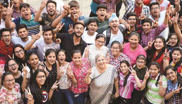 Students celebrate their class X examination results announced by the Central Board of Secondary Education (CBSE) at the DAV Public School in Amritsar yesterday.