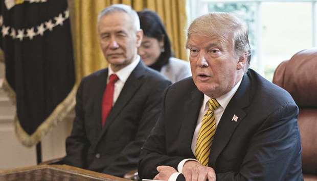 US President Donald Trump (right) speaks as Liu He, Chinau2019s Vice Premier, listens during a meeting in the Oval Office of the White House in Washington, on April 4, 2019. Negotiations about tariffs have been one of the remaining sticking points between the two sides. China wants the tariffs to be removed, while Trump wants to keep some, if not all, as part of any final deal to ensure China lives up to its commitments, a White House official said on Sunday.