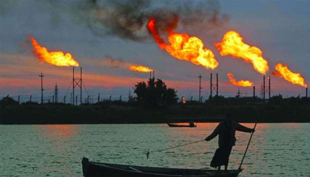 Flames emerge from flare stacks at the oil fields in Basra, Iraq