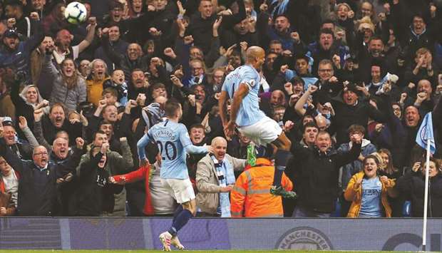 Manchester Cityu2019s Vincent Kompany (R) celebrates scoring against Leicester City on Monday night.