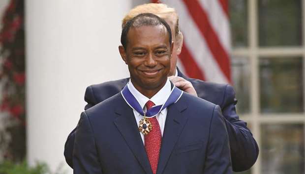 US President Donald Trump presents US golfer Tiger Woods with the Presidential Medal of Freedom during a ceremony in the Rose Garden of the White House in Washington, DC, on Monday.