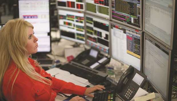 A trader works at the London Stock Exchange. The FTSE 100 lost 1.6 % to 7,260.47 points yesterday.