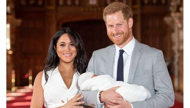 Britain's Prince Harry and Meghan, Duchess of Sussex are seen with their baby son, who was born on Monday morning, during a photocall in St George's Hall at Windsor Castle, in Berkshire