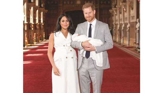 Prince Harry and Meghan, Duchess of Sussex, are seen with their baby son, who was born on Monday morning, during a photocall in St Georgeu2019s Hall at Windsor Castle, in Berkshire, yesterday.