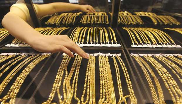 An employee arranges gold jewellery at a shop in Wuhan, Hubei province. The Peopleu2019s Bank of China raised its gold reserves to 61.1mn ounces in April from 60.62mn a month earlier, according to data on its website on Tuesday.