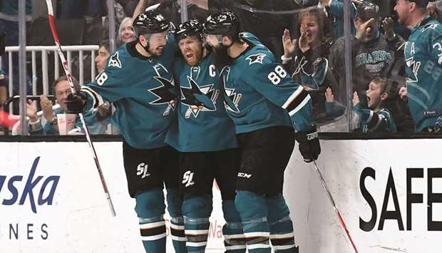 San Jose Sharksu2019 Joe Pavelski (centre) celebrates with teammates Tomas Hertl (left) and Brent Burns after scoring a goal against the Colorado Avalanche during the 2019 NHL Stanley Cup Playoffs. (AFP)