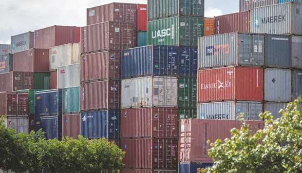 Shipping containers sit stacked at the Port of Brisbane. Announcing a three-phase plan on Friday, Australiau2019s Prime Minister Scott Morrison said he aims to incrementally reopen cafes, restaurants, gyms and cinemas, allow gatherings of up to 100 people and permit interstate travel.