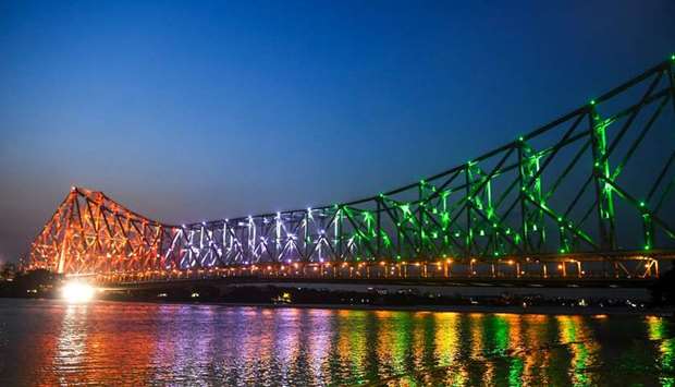 A general view shows the Howrah bridge illuminated with the national flag colours to honour the u2018frontline warriorsu2019 of the coronavirus, in Kolkata yesterday.