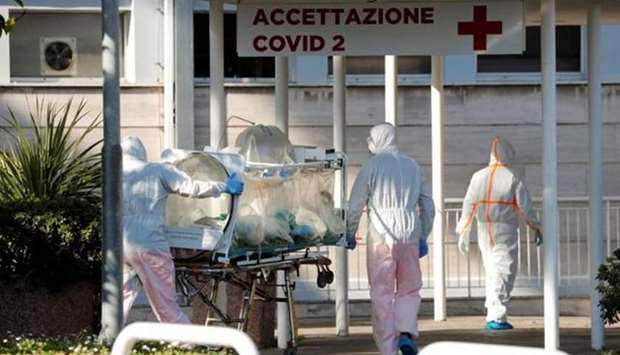 FILE PHOTO: Medical workers in protective suits push an isolation stretcher in front of the Columbus Clinic, where patients suffering from coronavirus disease (Covid-19) were moved from Spallanzani Hospital, in Rome, Italy. During the pandemic, Italians have felt abandoned by their European partners at a moment of existential crisis.
