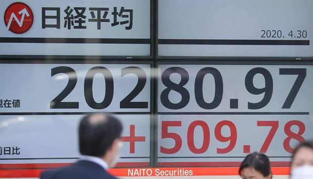An electronic quotation board displays share prices of the Tokyo Stock Exchange. Japanese stocks gained 2.1% to 20,193.69 points yesterday, tracking rallies on global stocks after news of positive trial results for a drug used in treating the new coronavirus.
