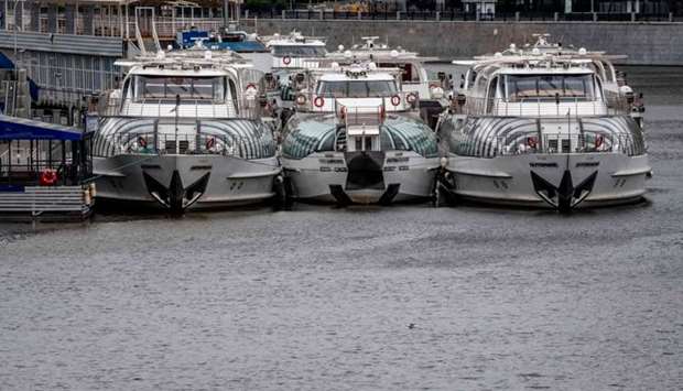 Pleasure yachts stand on the pier on Moskva river in central Moscow on May 10, 2020, during a strict lockdown in Russia to stop the spread of the novel coronavirus