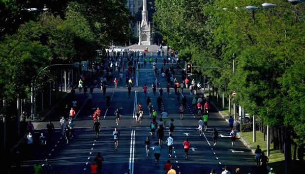 People exercise in Madrid yesterday during the hours allowed by the government to exercise, amid the national lockdown to prevent the spread of the coronavirus disease.