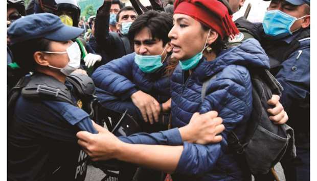 Police detain demonstrators during a protest against Indiau2019s newly inaugurated link road to the Chinese border, in Kathmandu yesterday.