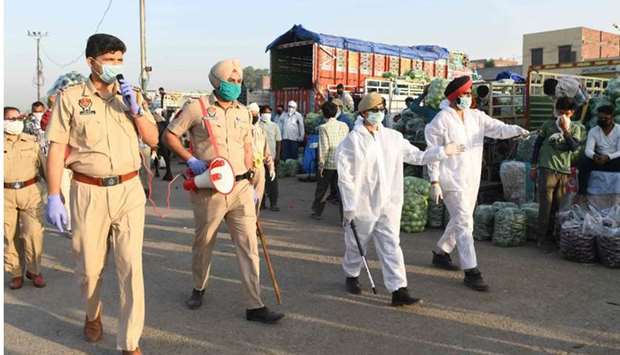 Punjab police personnel patrol at a vegetable wholesale market during a government-imposed nationwide lockdown as a preventive measure against the spread of the Covid-19, on the outskirts of Amritsar
