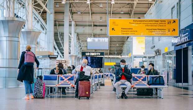 Passengers of a flight to Nur-Sultan wait before boarding a plane at Almaty International Airport, Kazakhstan