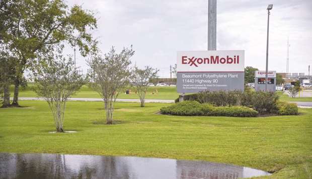 Signage stands outside the Exxon Mobil Corp Beaumont Polyethylene Plant in Texas. Exxon Mobil reported its first loss in over 30 years, and Royal Dutch Shell cut its dividend for the first time since the Second World War.