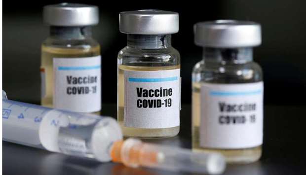 FILE PHOTO: Small bottles labelled with a u201cVaccine COVID-19u201d sticker and a medical syringe are seen in this illustration taken taken on April 10.