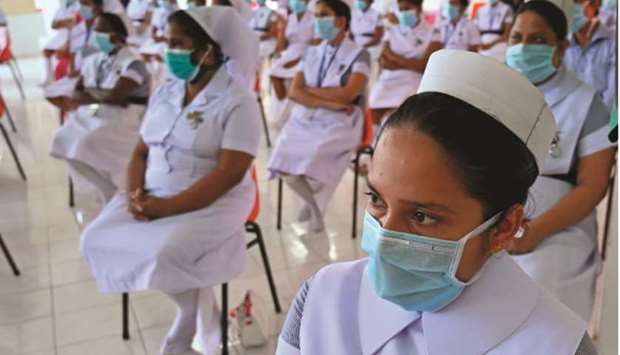 Nurses take part in a ceremony to mark International Nurses Day, celebrated on the birthday of Florence Nightingale, in Colombo yesterday.