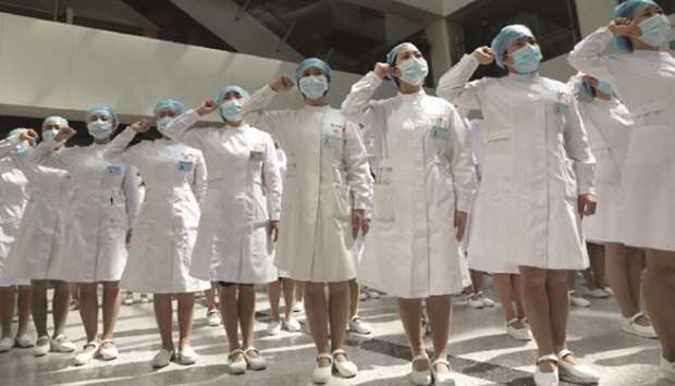 Nurses wearing face masks take part in an event held to mark the International Nurses Day, at Wuhan Tongji Hospital in Wuhan, the Chinese city hit hardest by the coronavirus disease (Covid-19) outbreak, in Hubei province, China.