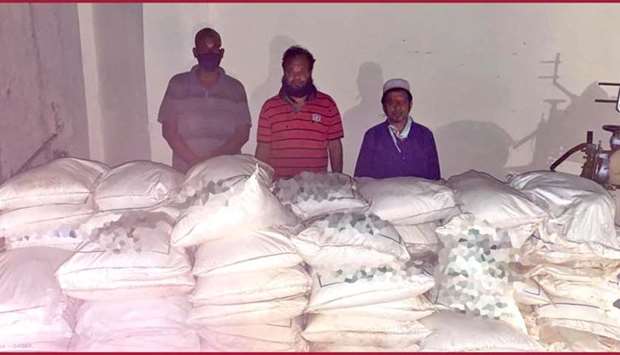 The three arrested men with the seized foodstuff.