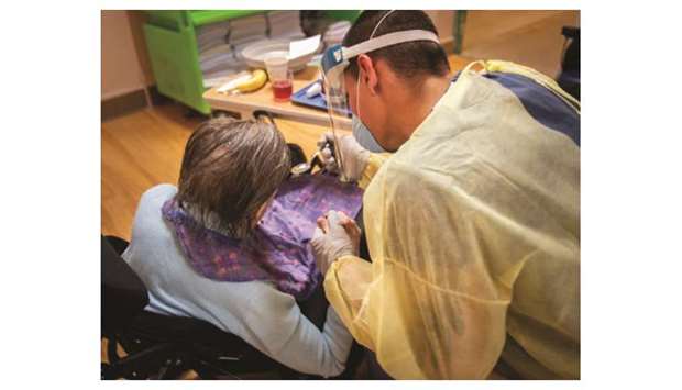 A Canadian Armed Forces handout photo of a soldier helping a senior citizen with her meal at the Grace Dart Long-Term Care Centre in Verdun, Quebec.